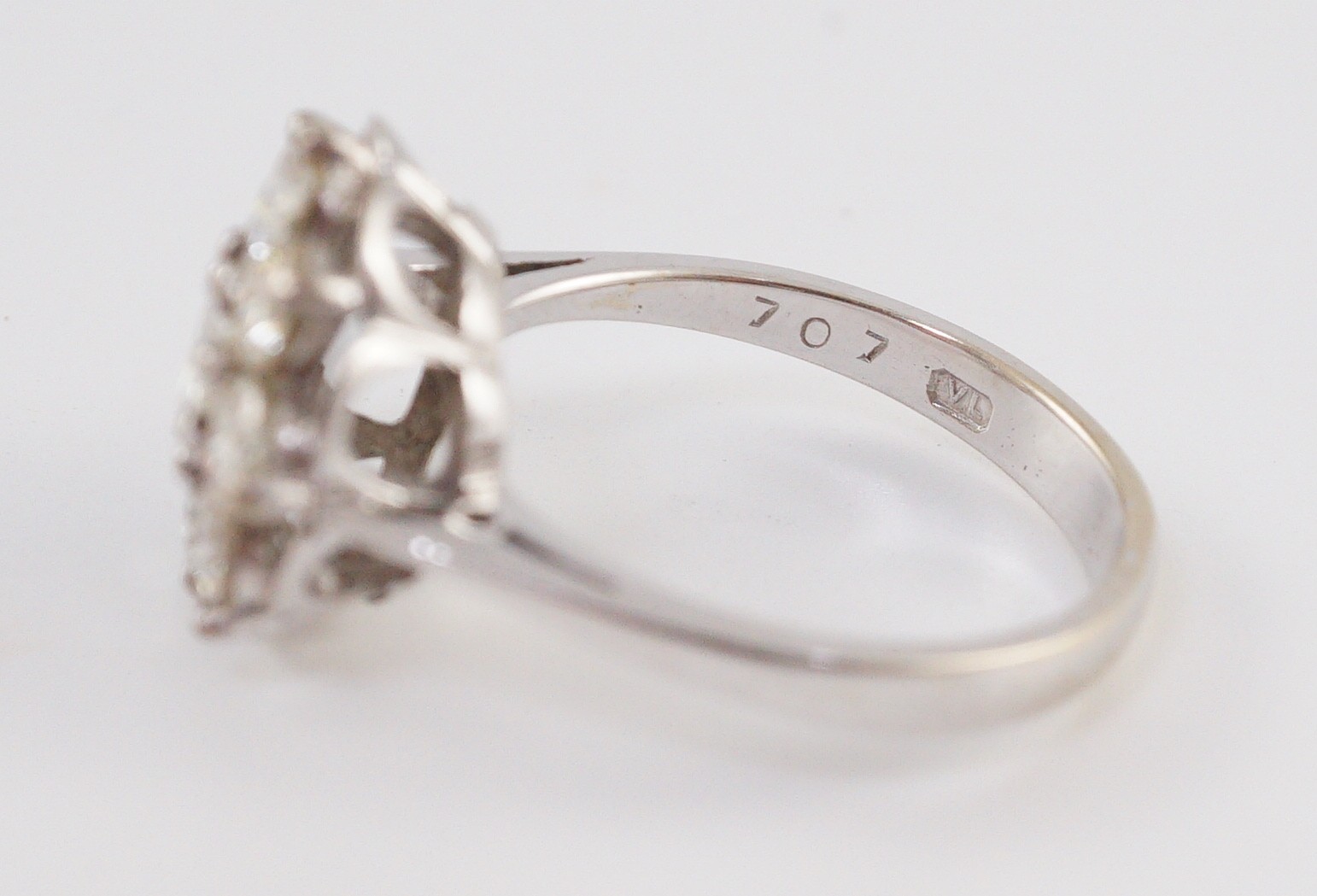 A modern 18ct white gold and nine stone diamond illusion set circular cluster ring